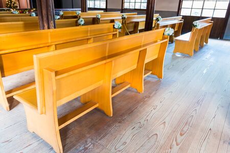 church interior with empty a row of wooden pews.のeditorial素材