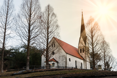 Countryside church in forest, autumn.の写真素材