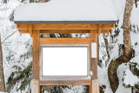 Wooden sign board, covered snow in winter concept.の写真素材