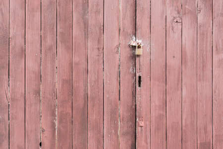 Old wooden wall texture with locked key.の写真素材