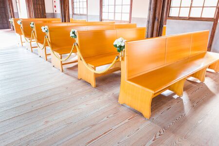 church interior with empty a row of wooden pews.のeditorial素材