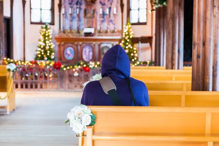 men in church interior sitting back on praying.のeditorial素材