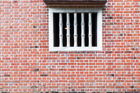 Old red brick wall with White Window.の写真素材