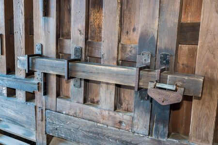 Old prison locked wooden key, wooden gate lockの写真素材