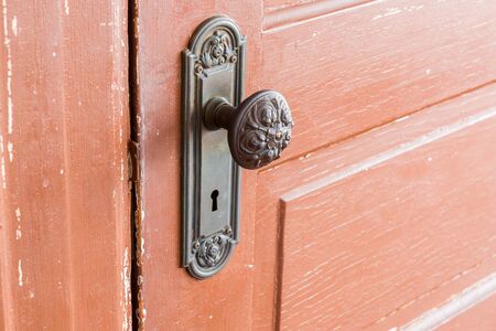 Traditional Door Knob on old wooden door. close up.の写真素材