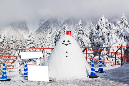 Snowman smiling with landscape in winter. snowfall.の写真素材