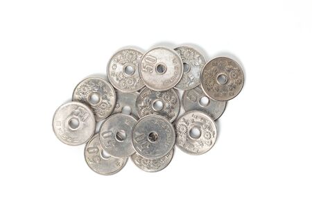 Pile of 50 yen coins japanese money, close up on white background.