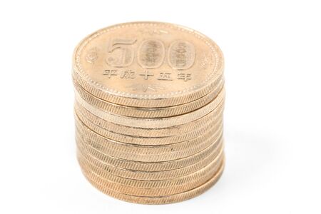 Pile of 500 yen coins japanese money, close up on white background.の写真素材