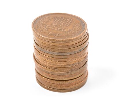 Pile of 10 yen coins japanese money, close up on white background.の写真素材