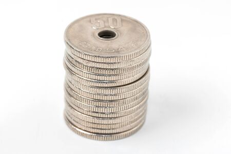 Pile of 50 yen coins japanese money, close up on white background.の写真素材