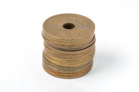 Pile of 5 yen coins japanese money, close up on white background.の写真素材