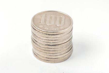 Pile of 100 yen coins japanese money, close up on white background.の写真素材