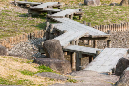 wooden bridge zigzagging on dry pond in Japanese garden. droughtの写真素材