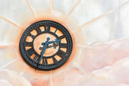 Retro wall clock on the wall with blank space.の写真素材