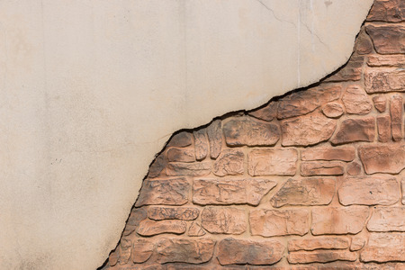 cracked red old brick with half traditional wallの写真素材