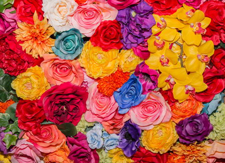 Beautiful multicolored artificial flowers background. flowers decor.の写真素材