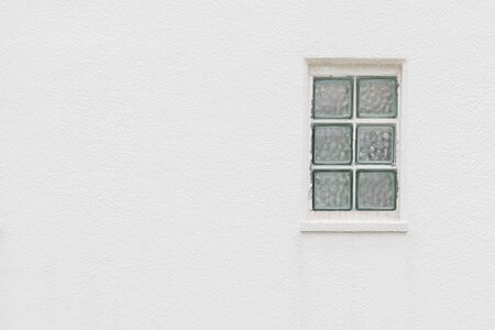 Empty wall with small window Detail of house exterior wall.の写真素材