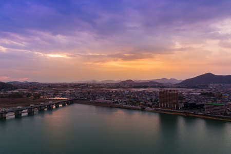 Landscape of inuyama city view with mountain and kiso river at sunset time.
