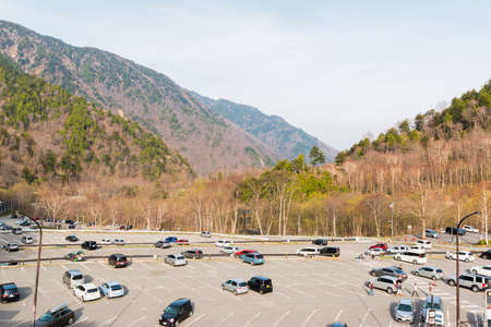 Aerial view of car parking outdoors with mountain in nature landscape.