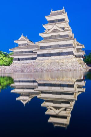 Matsumoto castle (Matsumoto-jo) historic landmark at night with beautiful reflection in water in matsumoto city nagano Japan.のeditorial素材