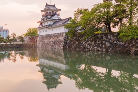 Toyama castle historic landmark in toyama city japan with beautiful sunset and reflection in water.のeditorial素材