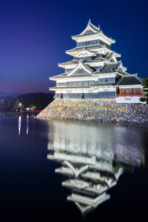Matsumoto castle (Matsumoto-jo) historic landmark at night with beautiful reflection in water in matsumoto city nagano Japan.のeditorial素材