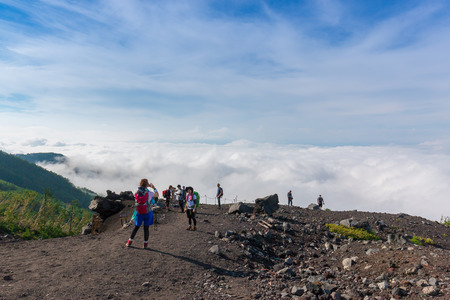 YAMANASHI, JAPAN - JULY 23, 2016 : Crowds of climbers at the summit. Most Japanese climb the Fuji mountain at night in order to be in a position at or near the summit when the sun rises. The morning light is called goraiko, "arrival of light".のeditorial素材