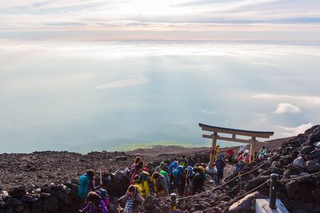 YAMANASHI, JAPAN - JULY 24, 2016 : Crowds of climbers at the summit. Most Japanese climb the Fuji mountain at night in order to be in a position at or near the summit when the sun rises. The morning light is called goraiko, "arrival of light".のeditorial素材