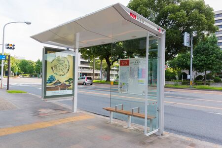 NAGOYA JAPAN - 2 JULY, 2016: Japanese bus stop, Japanese bus stop at front of Nagoya City Hall building and the clock tower.のeditorial素材