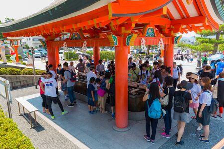 KYOTO, JAPAN - July 31, 2016: Tourists visiting Fushimi Inari shrine. Fushimi Inari Taisha is the head shrine of Inari, located in Fushimi-ku, Kyoto, Japan.のeditorial素材
