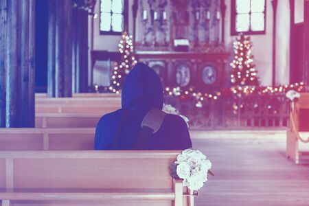 men in church interior with warm light styleの写真素材
