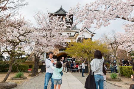 Inuyama, Japan - 2 April 2016: Inuyama castle historic building landmark in spring with beautiful cherry blossom. Tourist is enjoy viewing cherry blossoms.のeditorial素材