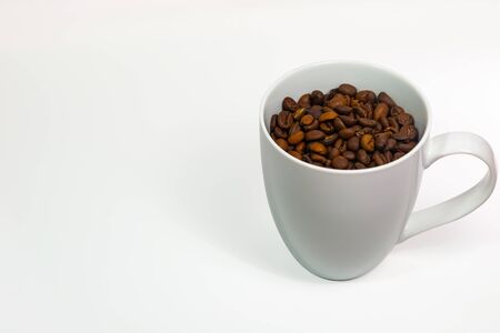 Coffee cup with coffee beans on white background.の写真素材