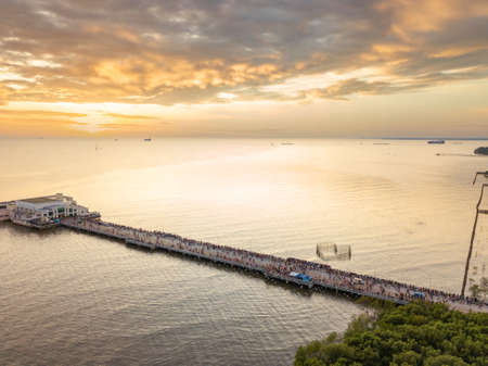 Landscape view  in sunset with seagulls and general cargo ship on backgroundの写真素材