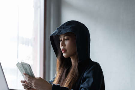 Hacker asia woman stealing data success from online computer systems by using laptop. concept of...