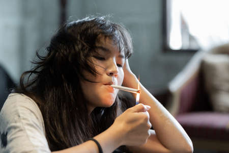 Asian girl smoking and hopeless concept, feeling be absent-minded, Lonely girl conceptの写真素材