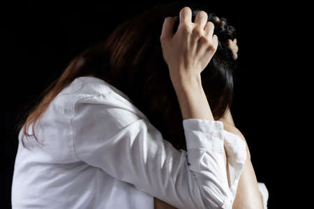 Domestic violence against a woman, Sexual abuse with a man attacking to a scared woman in a dark place, stop violence against Womenの写真素材