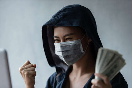 Hacker asia women stealing data success from online computer systems by using laptop. concept of...