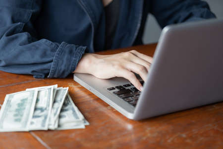 Hacker asia woman stealing data success from online computer systems by using laptop. concept of business malware and hackerの写真素材