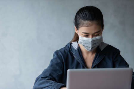 Hacker asia woman stealing data from online computer systems by using laptop. concept of business malware and hackerの写真素材