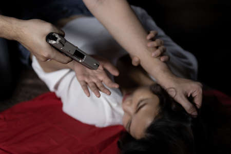 Robber raping asian young women with violence in an abandoned houseの写真素材