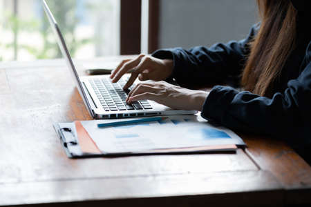 Hacker asia woman stealing data from online computer systems by using laptop. concept of business malware and hackerの写真素材