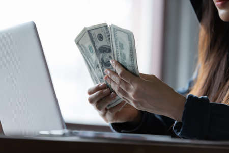 Hacker asia woman stealing data success from online computer systems by using laptop. concept of...