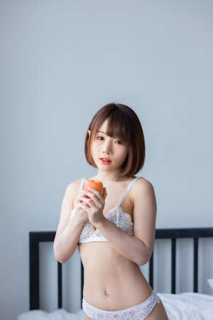 Portrait asian young woman wearing sexy bikini in bedroom. Sexy girl concept.の写真素材
