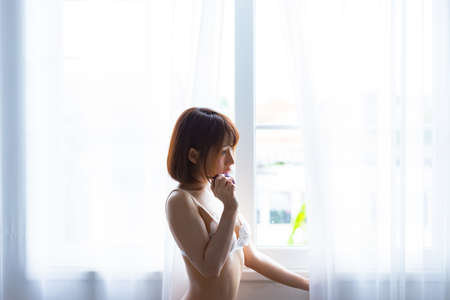 Portrait asian young woman wearing sexy bikini in bedroom. Sexy girl concept.の写真素材