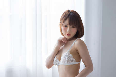 Portrait asian young woman wearing sexy bikini in bedroom. Sexy girl concept.の写真素材