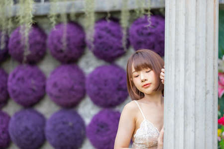 Portrait of young pretty sexy Asian woman wearing bikini in garden. Sexy girl feeling happy concept.の写真素材