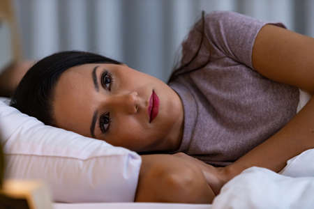 Young woman lying on the bed, that is sad quarrel with husband.の写真素材