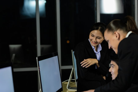 Business team working overtime late at night in call center office for support customer by online and phone. Concept for business at night.の写真素材