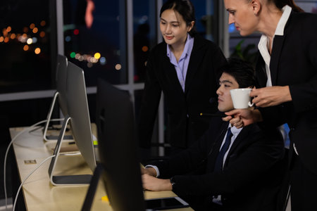 Business team working overtime late at night in call center office for support customer by online and phone. Concept for business at night.の写真素材